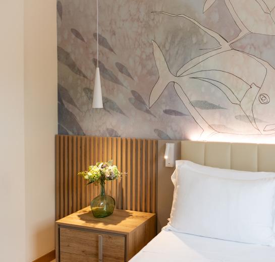 Bedroom with marine decorations and flowers on the nightstand.